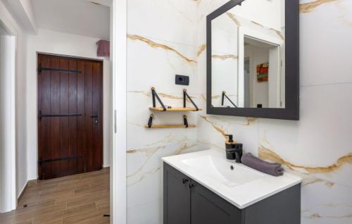 a bathroom with a sink and a mirror at Beautiful Casa Dea with pool in Opatija in Ičići