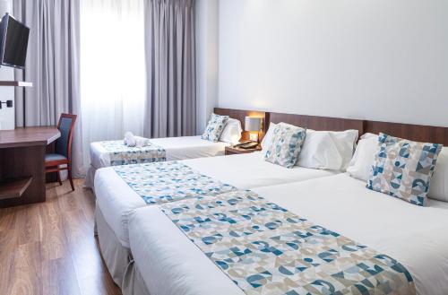Postel nebo postele na pokoji v ubytování Hotel Olympia Universidades