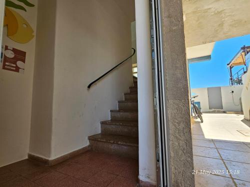 a staircase in a house with a stair case at Blife Ceriya private apartment in Faro