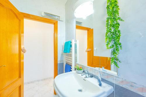 a bathroom with a sink and a mirror at Villa Mona - PlusHolidays in Ifach