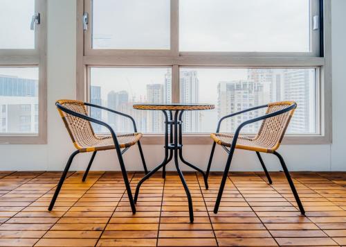 two chairs and a table in front of a window at The November Stay In landmark in Incheon