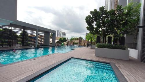 a swimming pool on the side of a building at Joan's Hideout Sky Trees Serviced Apartment 4 pax JB Aeon Bukit Indah in Johor Bahru