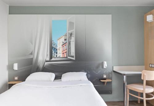 Postel nebo postele na pokoji v ubytování B&B HOTEL Rouen Centre