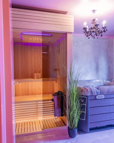 a sauna with a potted plant in a room at Golden Fish in Jungle Jacuzzi Sauna Sarajevo in Sarajevo