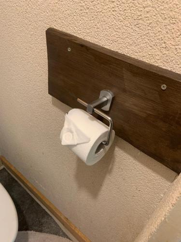 a toilet paper dispenser on a wall in a bathroom at Jalaka, Nice 2-bedroom apartment - 1 big bed - 2 single bed in Tartu