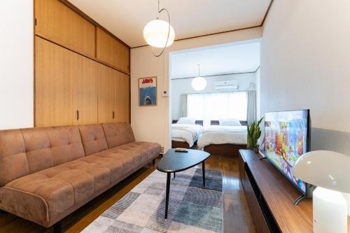 a living room with a couch and a bed at Animal Art Apartment Type 12 in Tokyo