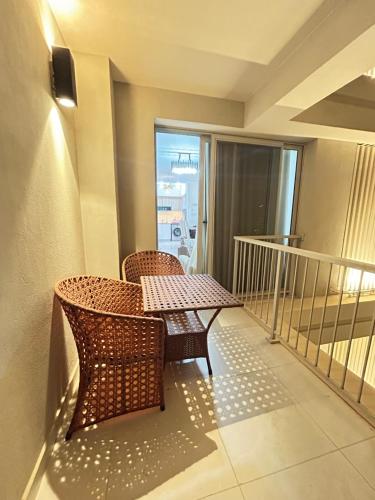 a balcony with a table and chairs on a balcony at Chalet at Marassi, Marina West in El Alamein