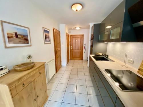 a kitchen with a sink and a counter top at Birkennest in Zingst