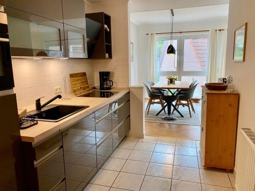 a kitchen with a sink and a table at Birkennest in Zingst