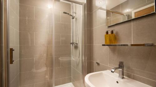 een badkamer met een douche en een wastafel bij Budle Bay Loft in Bamburgh