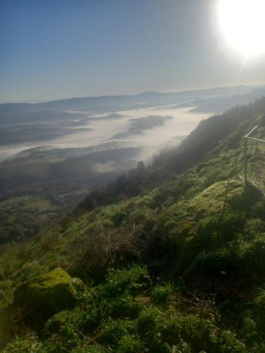 a view from the top of a hill with a foggy valley at Autenticum Agriturismo Tolfa in Tolfa