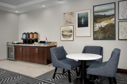 a meeting room with a table and chairs at Homewood Suites by Hilton Seattle/Lynnwood in Lynnwood
