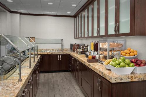 a large kitchen with fruits and vegetables on the counter at Homewood Suites by Hilton Seattle/Lynnwood in Lynnwood