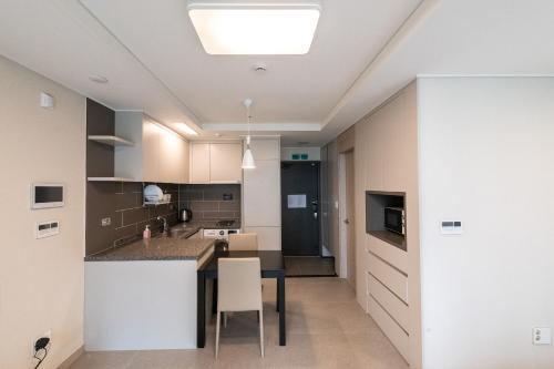 a kitchen with a table and chairs in a room at The November Stay In landmark in Incheon