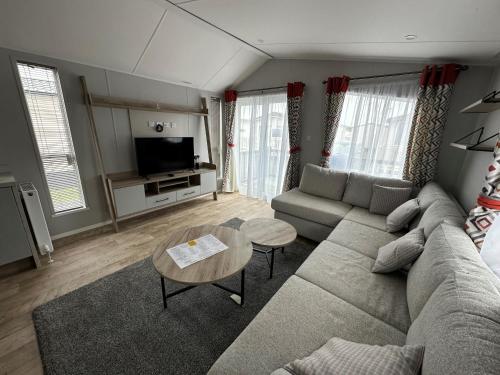 a living room with a couch and a table at Royal Oak Caravan Park in Skegness