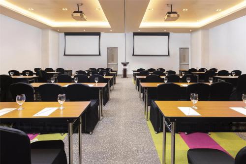 an empty room with tables and chairs and screens at Park Inn by Radisson North Edsa in Manila