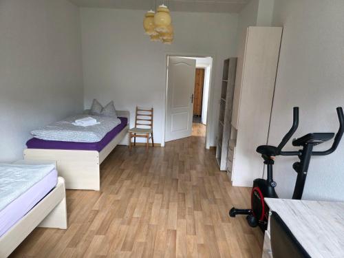 a room with two beds and a exercise bike in it at Ferienwohnung nahe Elsterwiese in Zeitz
