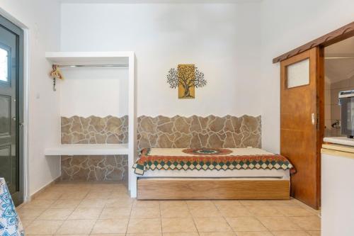 a room with a bed in the corner of a room at Mouria Studio 4 in Kithnos
