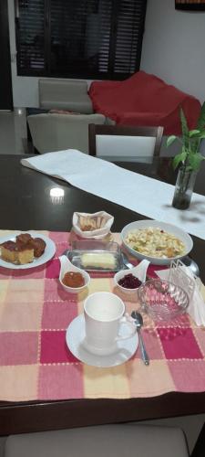 a table topped with plates of food on a table at Bienvenidos a mi casa in Chajarí