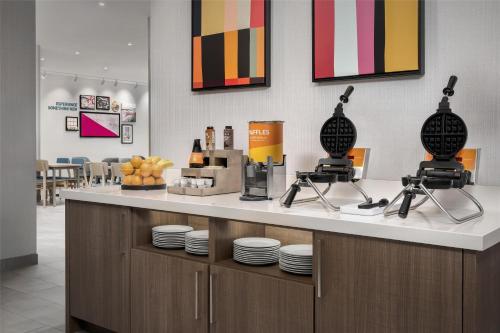 a counter in a restaurant with plates on it at Home2 Suites By Hilton Tooele in Tooele