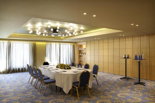 a conference room with a long table and chairs at Wyndham Grand Athens in Athens