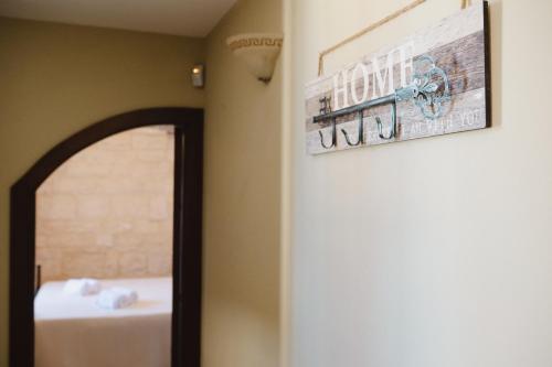 a mirror in a room with a picture on the wall at TRULLO MALVISCHI - Privacy & Pool in Alberobello