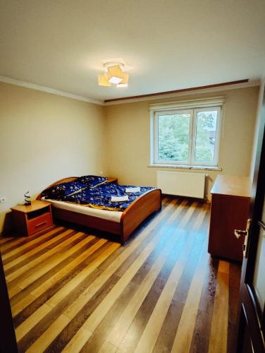 a bedroom with a large bed and a window at Zacisze Grojeckie in Grojec