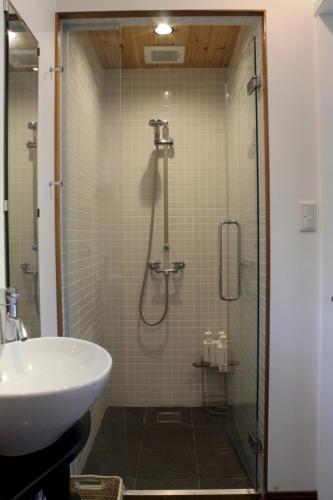 a bathroom with a shower and a sink at Forest Hideaway in Niseko
