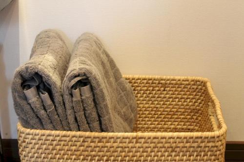 a wicker basket with two towels in it at Forest Hideaway in Niseko