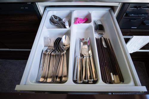 a tray with forks and spoons and utensils at Forest Hideaway in Niseko