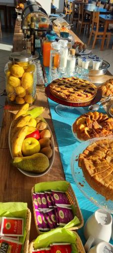 a long table with pies and other food on it at Hotel Mare Blu -- boutique in Pineto