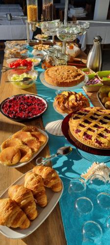 a table with many different types of pies and pastries at Hotel Mare Blu -- boutique in Pineto