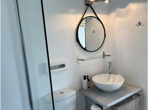 a bathroom with a sink and a mirror at La Priva Calma in Agios Ioannis