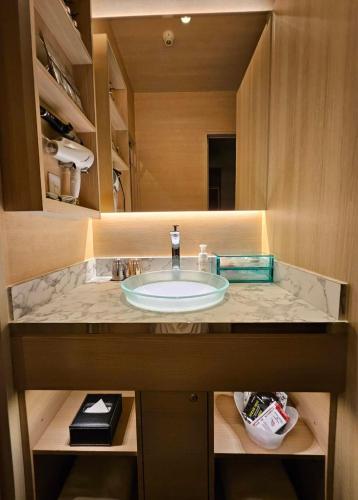 a bathroom sink with a marble counter top at Hotel Sulata Yamagata Airport in Higashine
