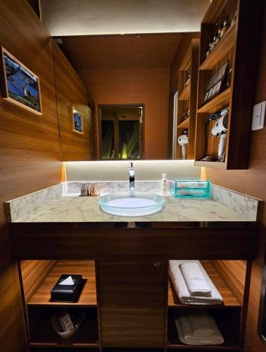 a bathroom with a sink and a large mirror at Hotel Sulata Yamagata Airport in Higashine