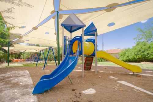 a playground with a slide in a park at pisgat shoresh in Shoresh