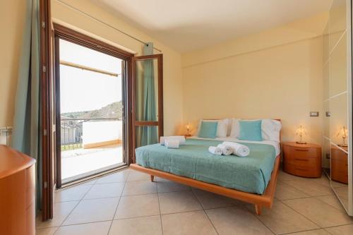 a bedroom with a bed and a large window at A Casa di Sofi in Marco Simone