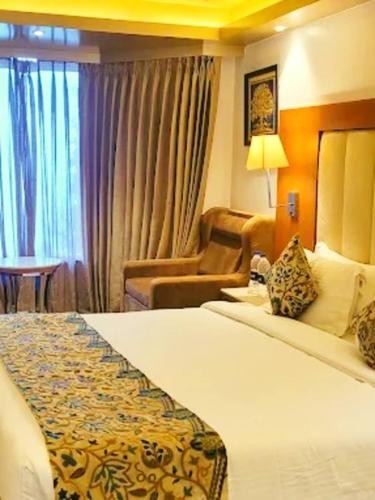 a hotel room with a bed and a chair at The Royal Glacier in Gulmarg