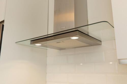 a stainless steel stove hood in a kitchen at A Casa di Sofi in Marco Simone