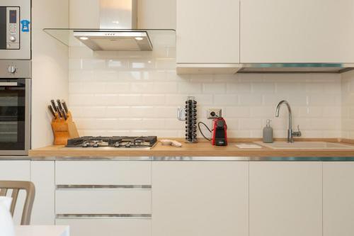 a kitchen with white cabinets and a counter top at A Casa di Sofi in Marco Simone
