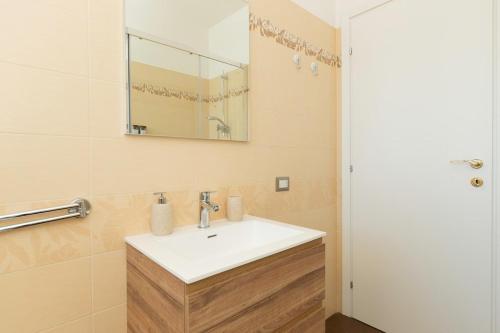 a bathroom with a white sink and a mirror at A Casa di Sofi in Marco Simone