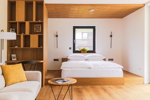 a bedroom with two beds and a couch at Vila Nina Bohinj in Bohinj