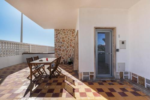 a patio with a table and chairs on a balcony at Blife Riamya private apartment in Faro