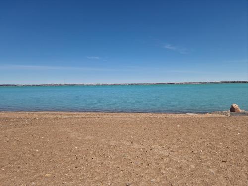 an empty beach with the ocean in the background at Сдаётся недалеко от озера в тихом уютном месте жилой дом in Balqash