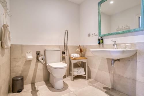 a bathroom with a toilet and a sink at La Residencia Puerto Hotel & Spa in Tarifa