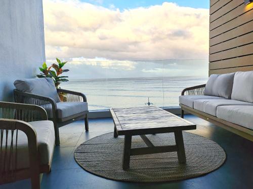 a living room with a view of the ocean at Wavescapes Endless Ocean in Muizenberg
