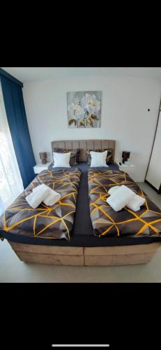 a large bed in a bedroom with two pillows at Bella Vista Sunset penthouse with private jacuzzi in Novalja