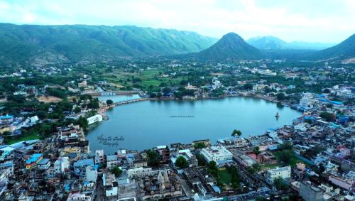 an aerial view of a city with a large body of water at Hotel Ajanta in Pushkar