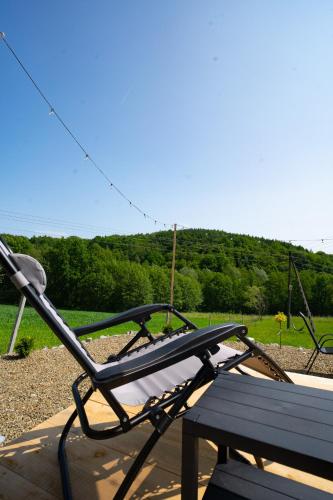 a bench sitting next to a park with a view at Bunkier House in Niedźwiada