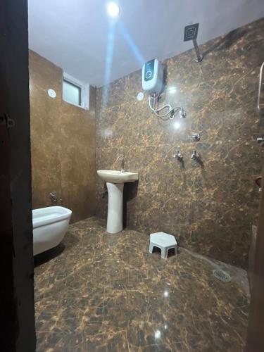 a bathroom with a toilet and a sink and a camera at Tejas Dream Hotel 300 meters from GOLDEN TEMPLE in Amritsar